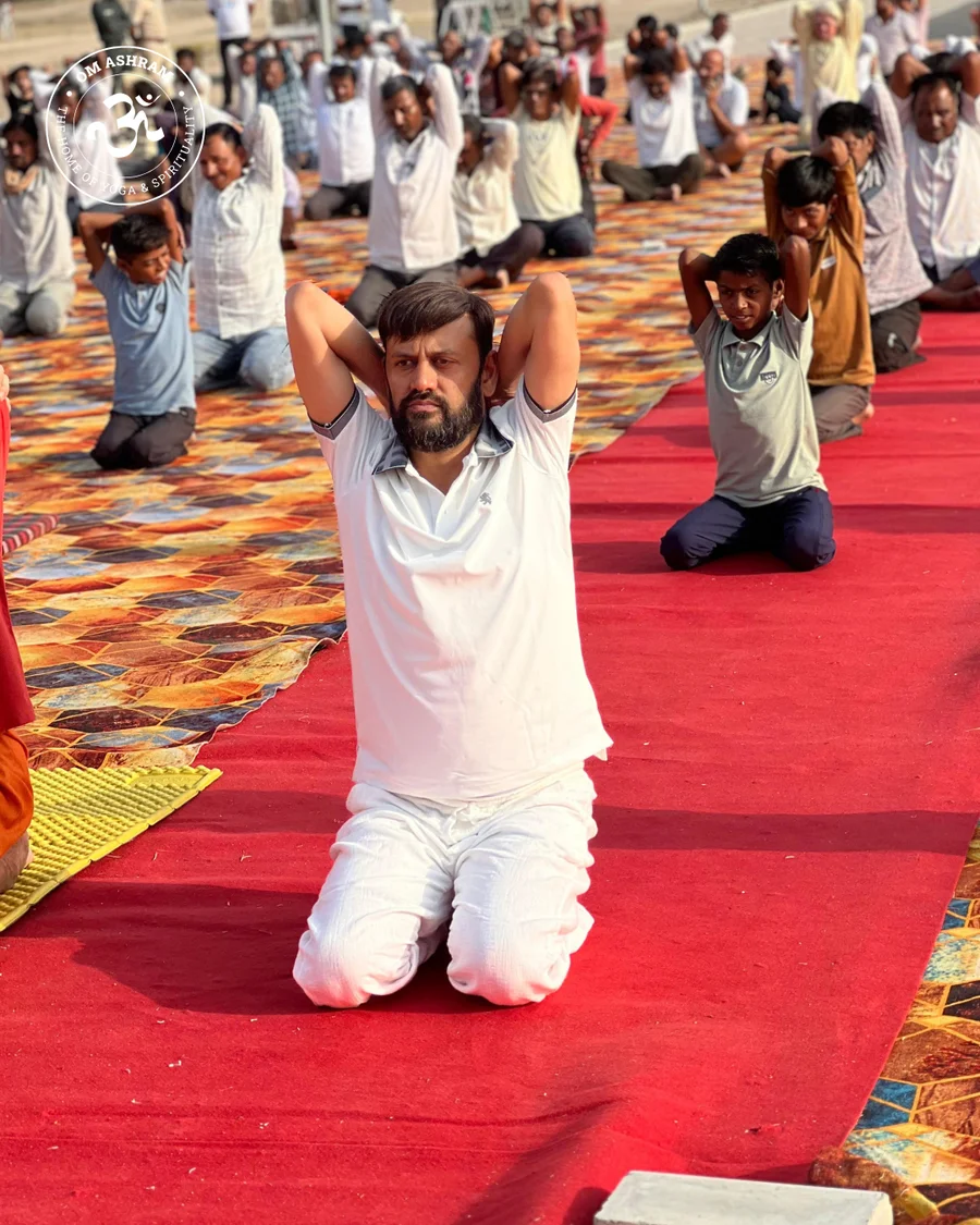 A group of men practicing traditional yoga asanas on mats in Jadan, Rajasthan.